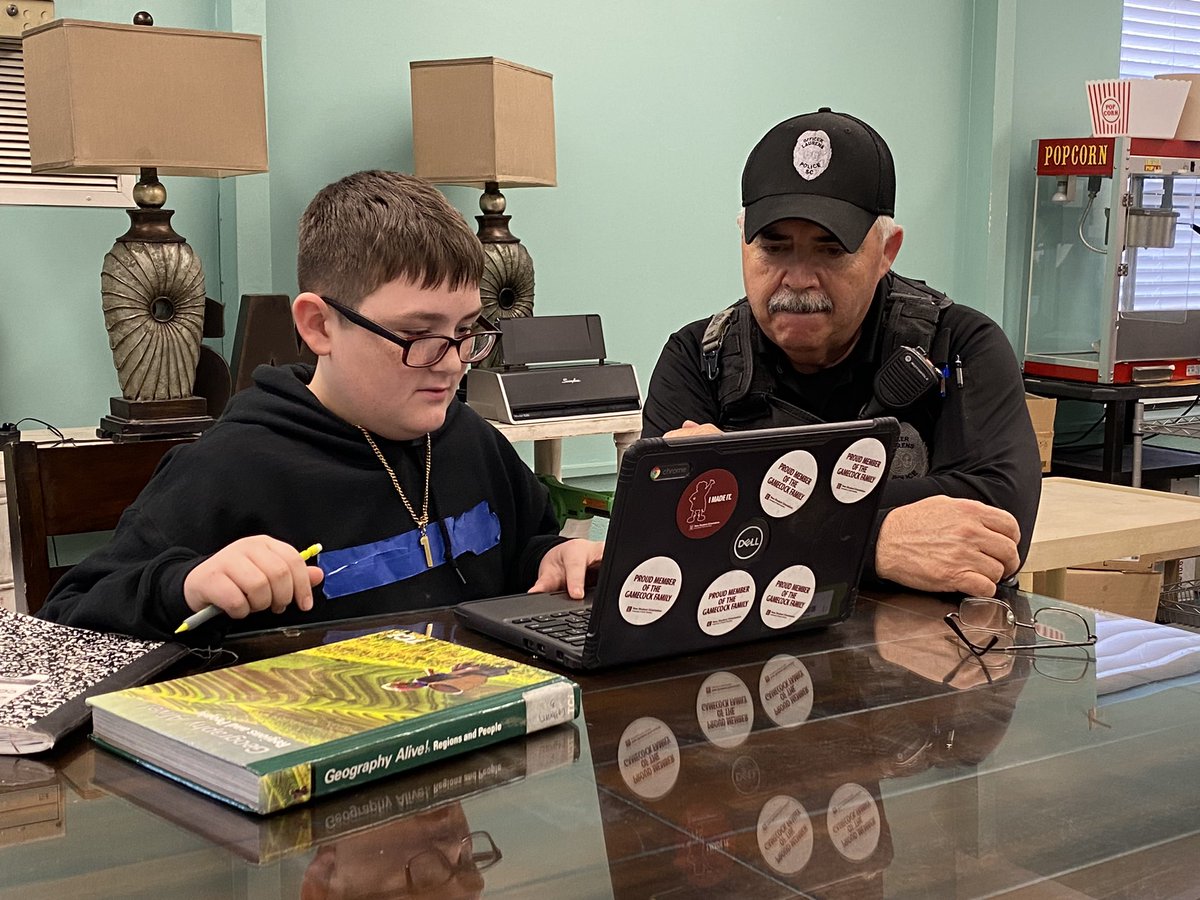 SandersMiddle55's tweet photo. Our SRO rocks @SandersMiddle55! Taking time to tutor & mentor is just 1 of Officer Tomlinson’s many talents. He diligently assesses & monitors our campus for safety. #NationalSROAppreciationDay #RocknLearn @LCSD55 @LCAdvertiser @loveSCschools @864Dawkins_ https://t.co/e76fptrjJo