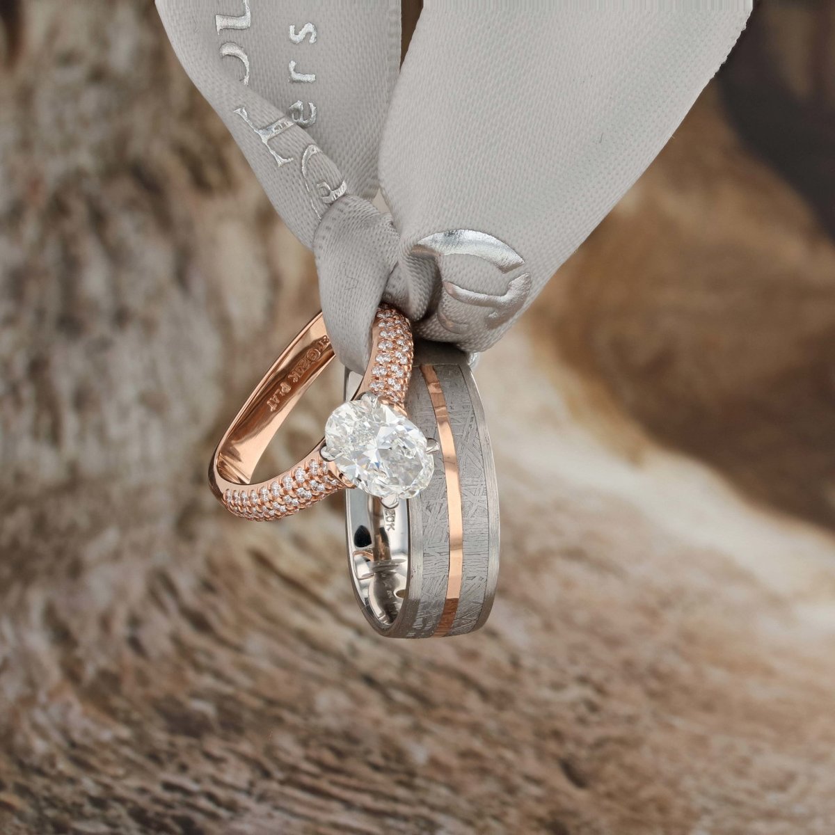 How about this wedding set? Oval diamond set in platinum and rose gold with a men's meteorite band. #weddingrings #bridalset #coffinandtrout
