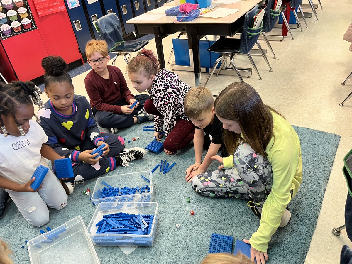 Using base ten blocks to add 3digit numbers in second grade.
