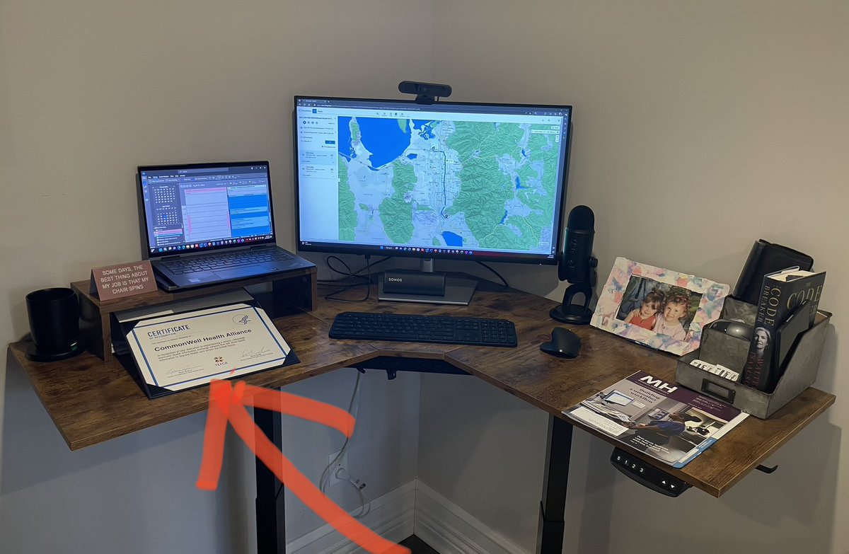 Your company proudly earns a recognition certificate from HHS/ONC. Company is virtual so no office to display it. Have a relatively neat standup work space & may move to different spot in home w/out walls. Where does the certificate go (red arrow)? Can’t bump the pic of my girls.