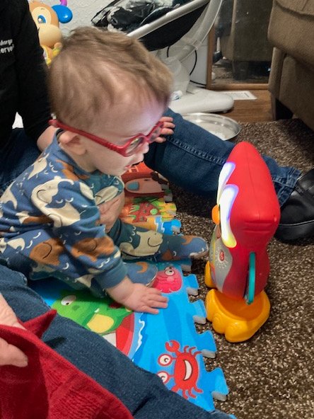 PIPBVI's tweet photo. Little Leighlend is doing so great with his new glasses! We had fun playing with his owl toy that plays music and lights up! It definitely keeps his attention during tummy time!  What a fun toy for our growing PIP-BVI kiddos!  -Margaret Caulford, M.Ed., TVI  USDB PIP BVI https://t.co/V2IygqUJib