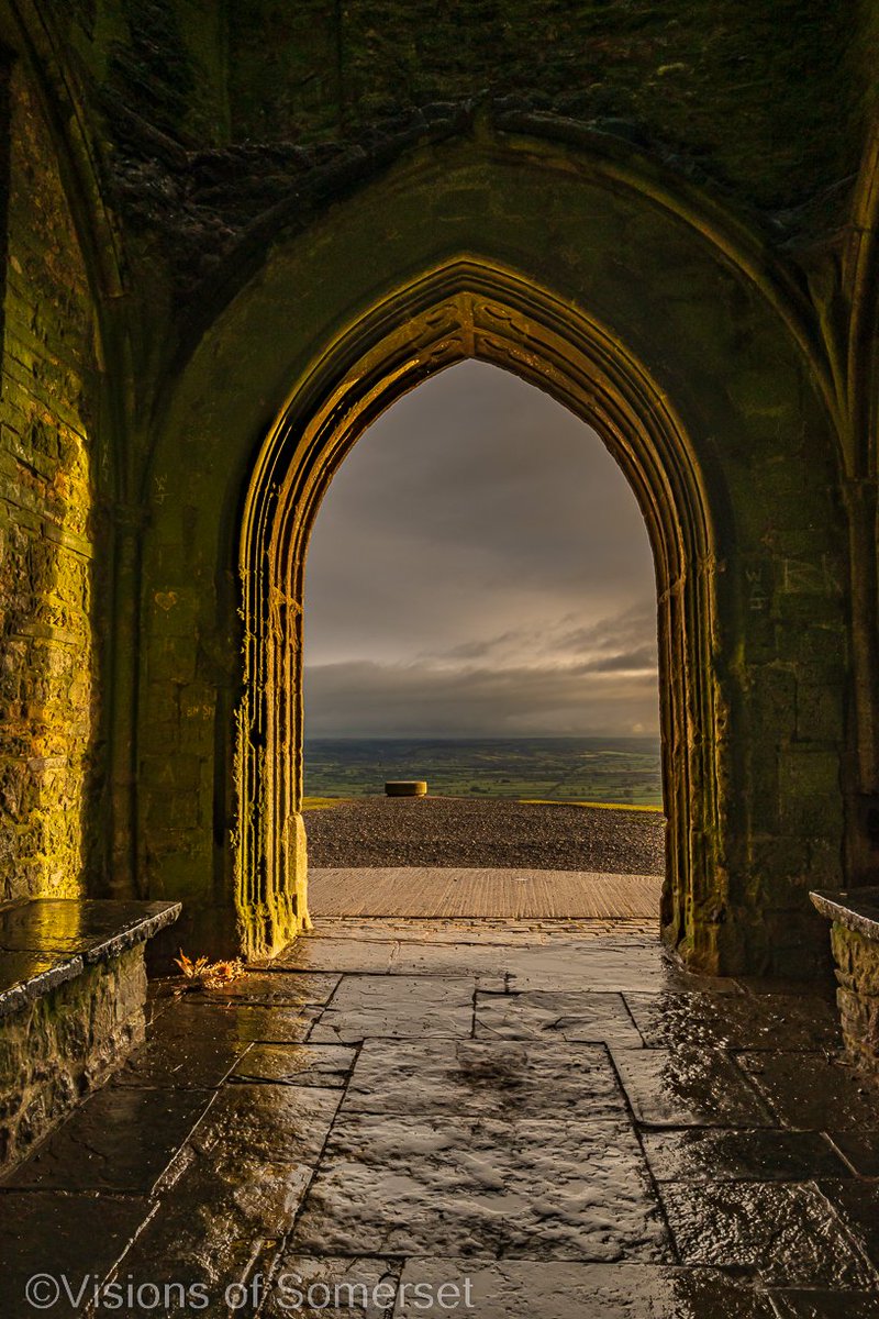 Glastomichelle's tweet photo. The flowers in the archway. Shortly after the rain came the sun (for a moment 😂). This morning on Glastonbury Tor. https://t.co/WKVOt2neZg