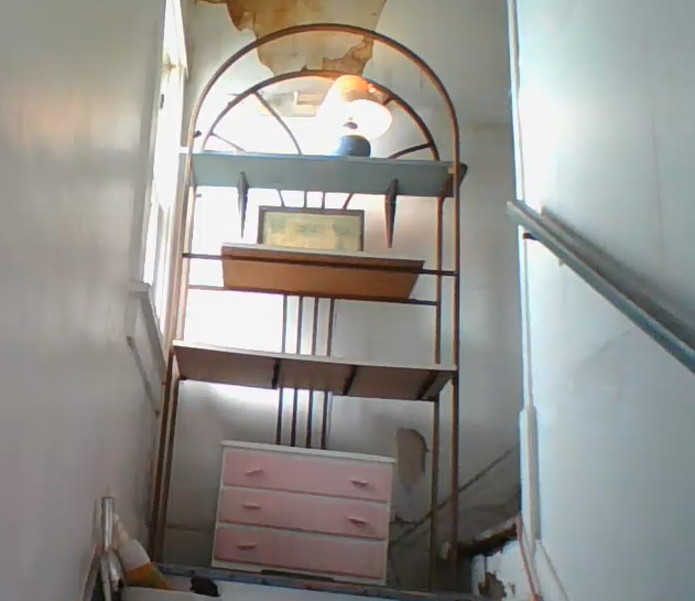 Vista15's tweet photo. Wanna see what I was doin' today?  Moved this shelf unit AND lamp up onto my landing.  City says it is inappropriate for my porch.  (I've been fighting them since 2017!  A new roof and soffits on north and south sides of my house didn't satisfy them.) https://t.co/V6lhs1pqkS