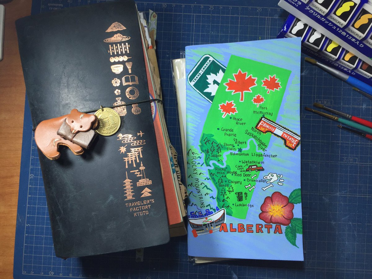 This is my Traveler's Notebook Kyoto Edition, with a Kyoto charm, and a bear keychain that I repurposed as a charm. It sits next to an insert that I customised to feature the map of Alberta on the front, similar to the California style one released by Traveler's Company USA.
