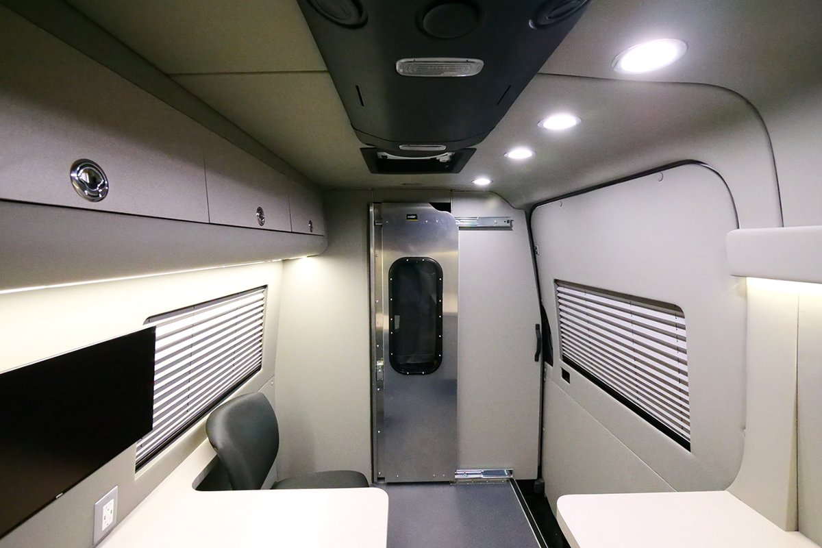 HQCustomDesign's tweet photo. This Mobile Office conversion includes a spacious desk, rolling chairs, a 20” monitor, and a separation wall with a sliding door. It has a custom cabinet for storage, a refrigerator, overhead cabinets, and window shades.
https://t.co/Jb4kyhT8Xm 
.
.
 #customvehiclebuild https://t.co/8ajYaN4C5L