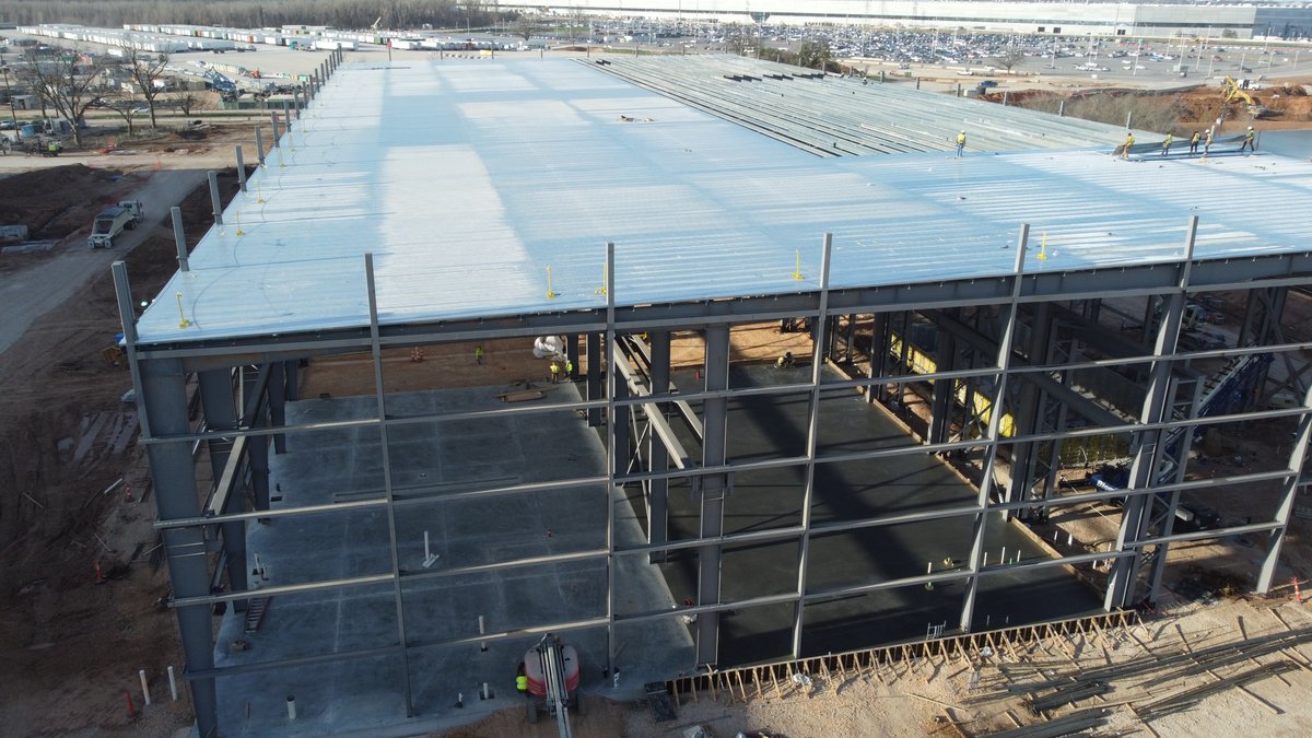 JoeTegtmeyer's tweet photo. 17 February 2023 Giga Texas IMAGES! Cold &amp; windy! Paint S end continues, W entrance concrete, trees &amp; trenching. Roof solar lighting, E traffic circle progress &amp; supercharger canopy. Switchyard footings for “A-frame” &amp; Die shop progress! More in my YouTube video later today! https://t.co/jGLSpaQdMg