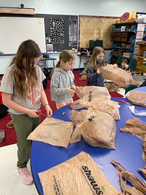 Second and third grade repurposing project; weaving sleeping pads for animal shelter kennels.  A local Hollis community member will place these into pillowcases she sews from recycled fabric!