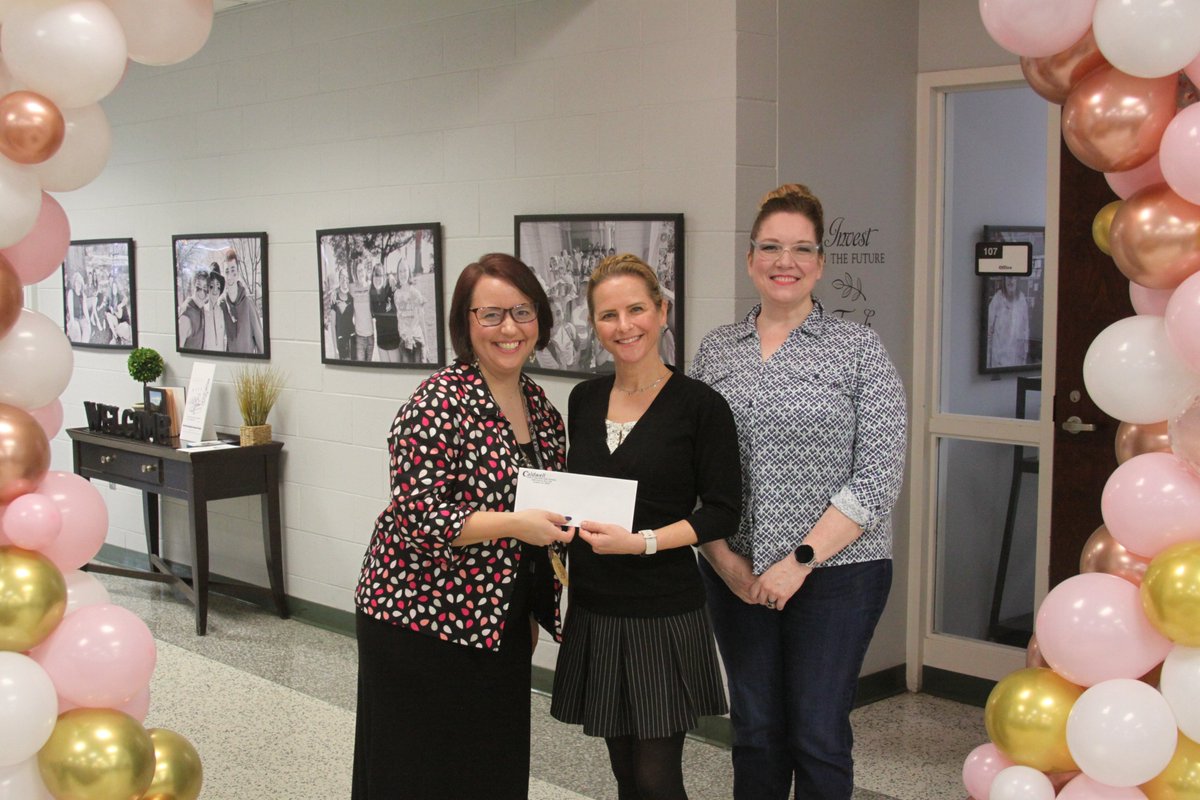 Cindel Chavers, 12th-grade seminar teacher and Interact Club Advisor, presents a donation on behalf of the Interact Club to April Jacob, MMS, PA-C, Medical Provider and Shellie Bowlin, Executive Director of <a href="/RobinsNestCAC/">Robin's Nest Children's Advocacy Center</a>  a children's advocacy center for abused children.