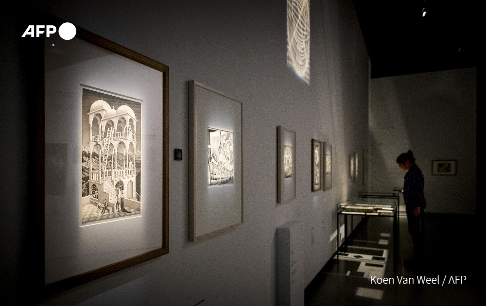 AFP's tweet photo. The mind-bending works of Dutch graphic artist MC Escher will tantalize viewers at new exhibition opening this weekend in The Hague https://t.co/E47kUCqRQE https://t.co/uc9aTv3uND