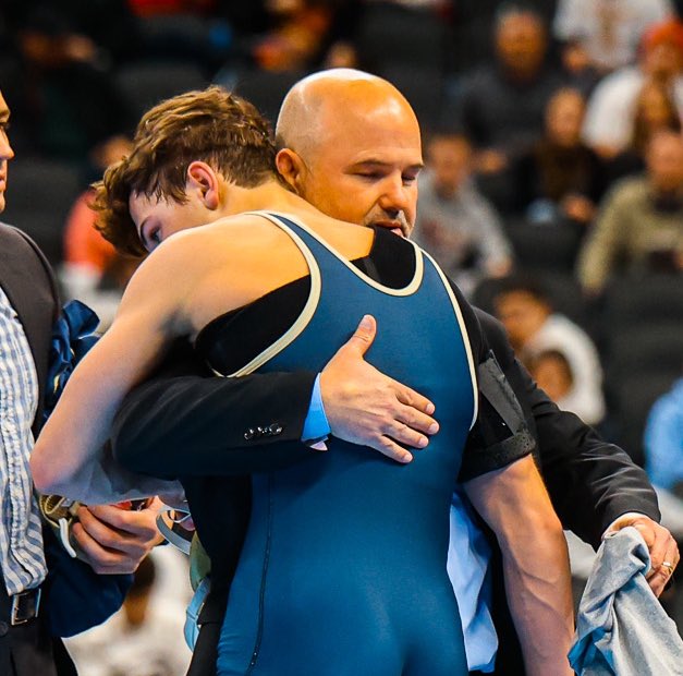 Favorite photo of day 1 of the <a href="/IHSAA1/">IHSAA</a> wrestling finals. <a href="/ChsSwamp/">Cathedral Wrestling</a> Coach McGinley hugs his son, senior Max McGinley, after a tough loss. Max fought through a painful shoulder injury to finish the match.