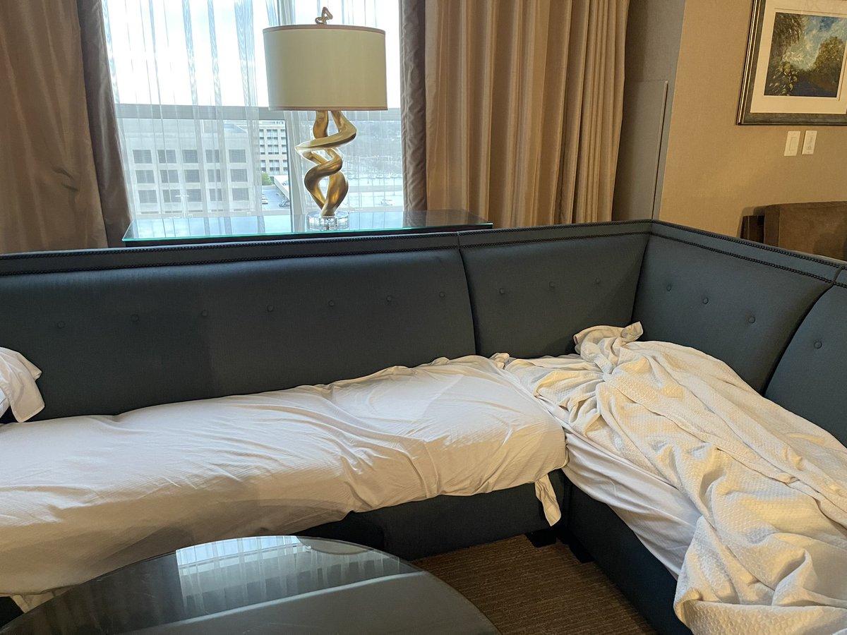 OneKup's tweet photo. How @HiltonHotels treats their #diamond status members. Literally having to sleep on a dirty couch hoping these sheets do their thing #hiltonhonors https://t.co/jzBfmxTtTo