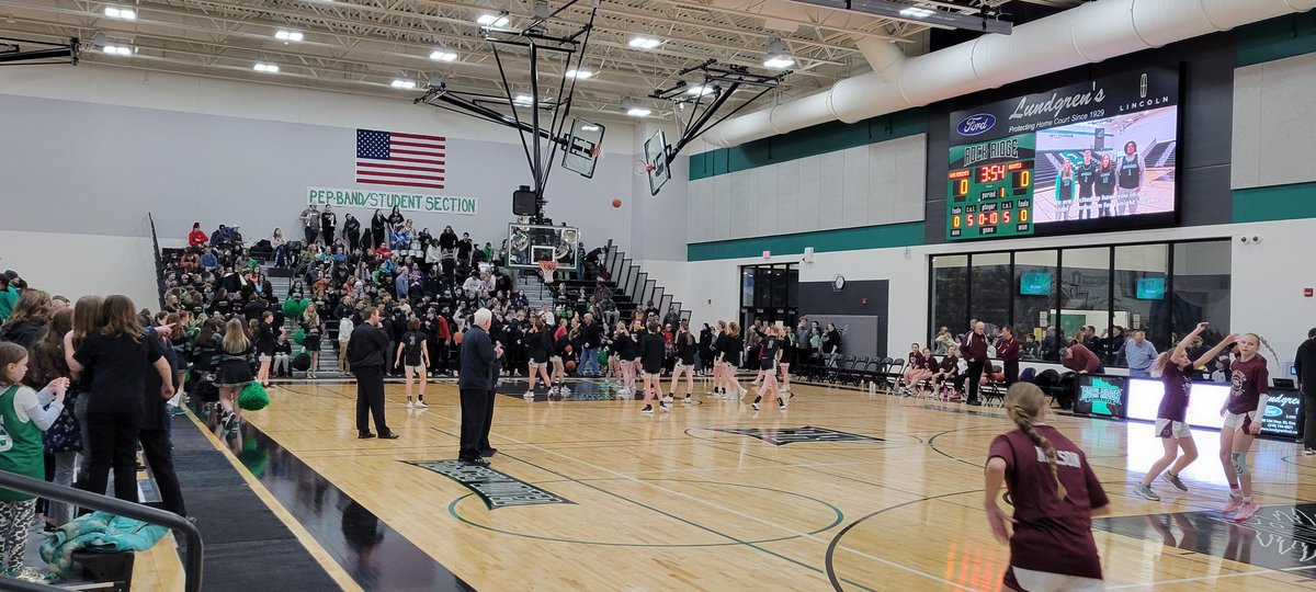 What an atmosphere for the first athletic event at Rock Ridge. Parking lot is packed, bleachers are filling up, pep band is rocking. Perfection.