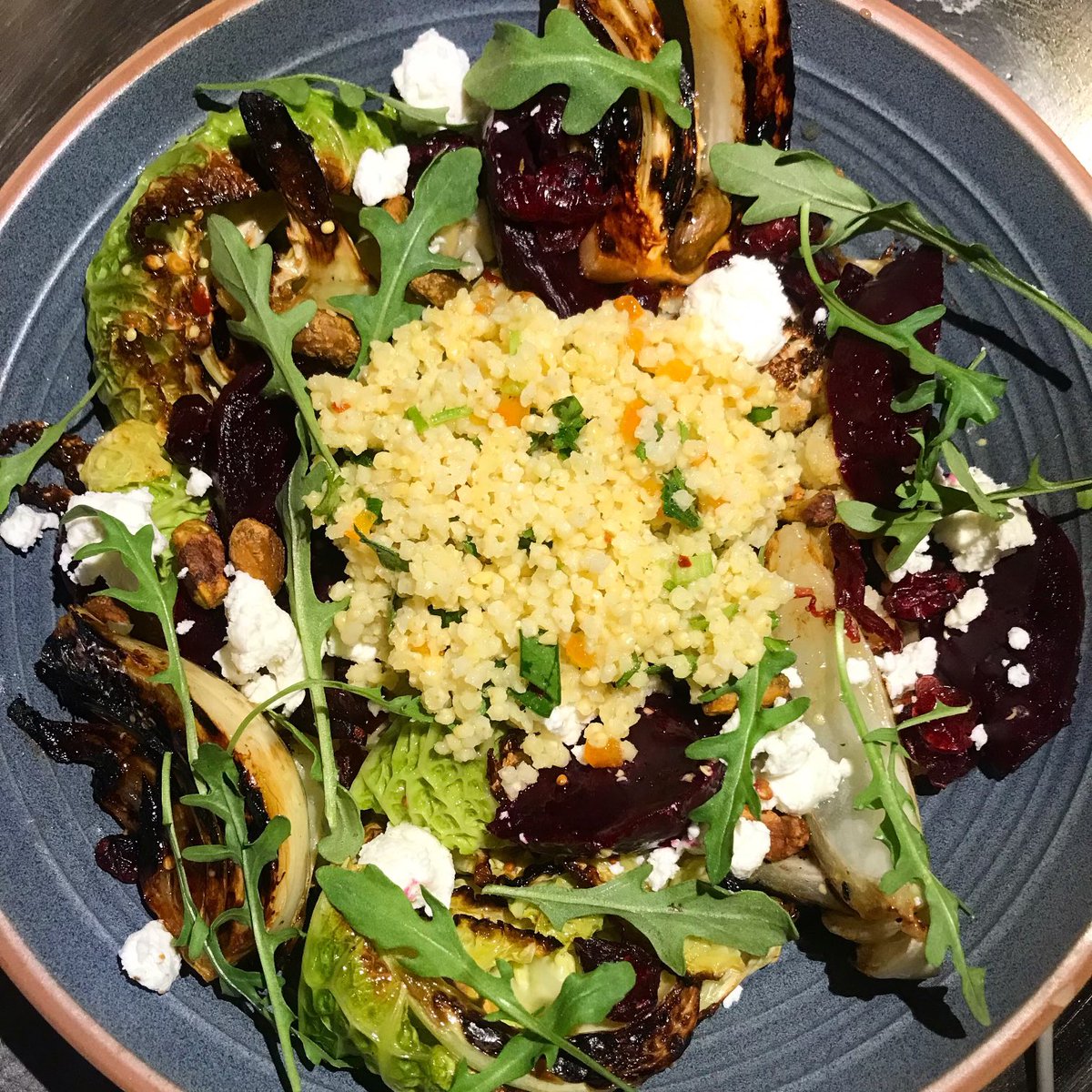 This one’s for my aunt. She used just eat bowls of boiled millet. We are expanding on that idea with our warm winter salad of Savoy cabbage, roasted cauliflower, fennel, pistachios and cranberries around a little mullet salad.