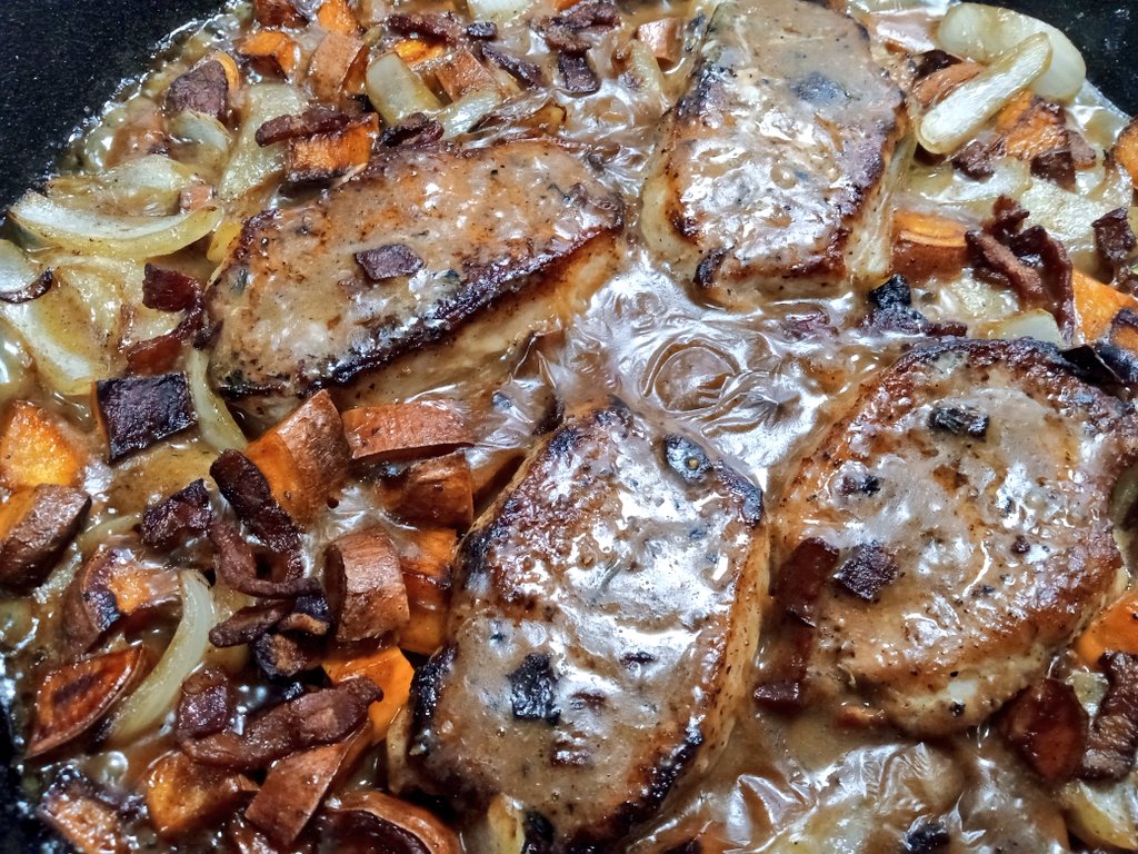 Center cut loin chops with sweet potatoes and onions in a white wine, roasted garlic and bacon pan sauce. 
#OnePanMeals