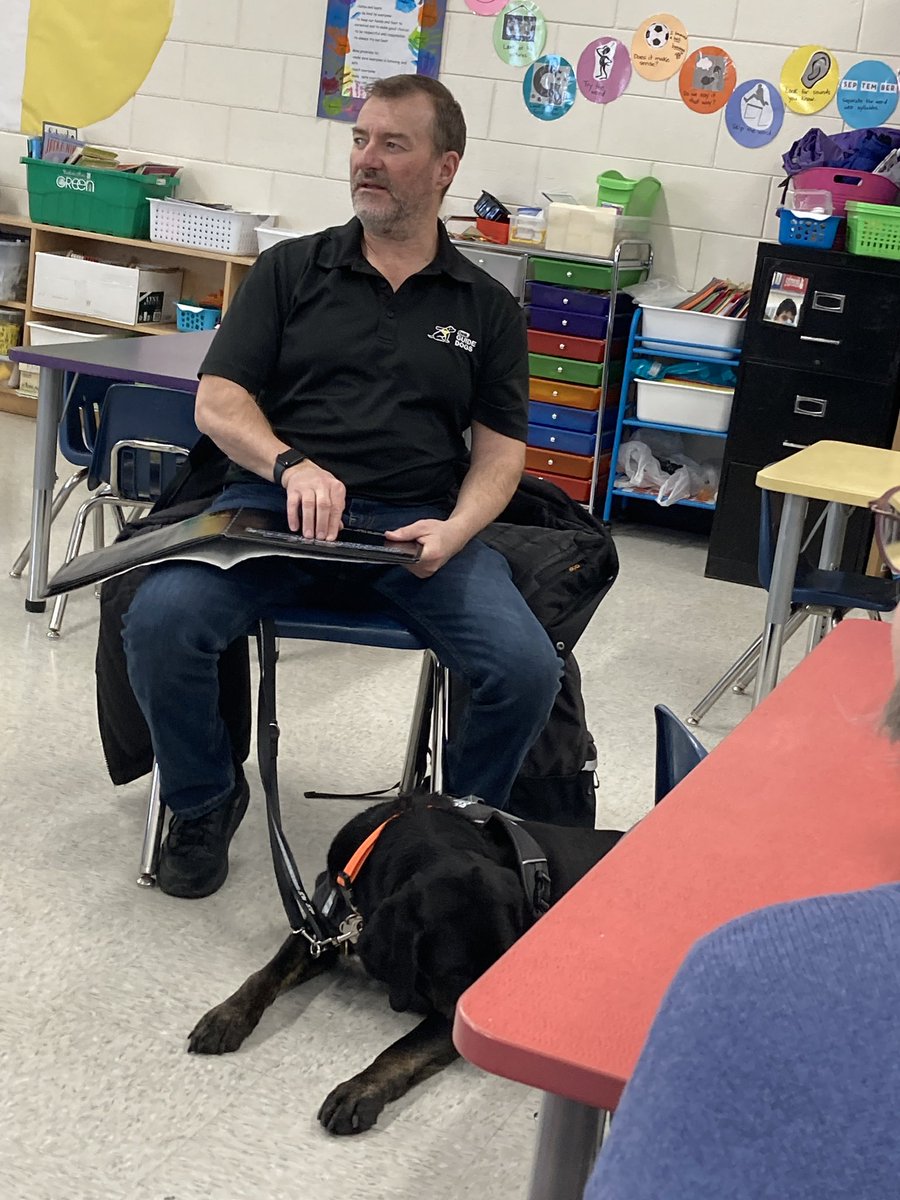 esmp_RETSD's tweet photo. Yesterday, Grade 1 classes at ESMP welcomed Tracey Garbut from CNIB and his dog, Marion, for I Love To Read. Tracey read to classes and spoke about adaptations that are important for him. He also talked about Guide Dogs and our responsibilities around them. @RETSDschools https://t.co/Jachh3L9g8
