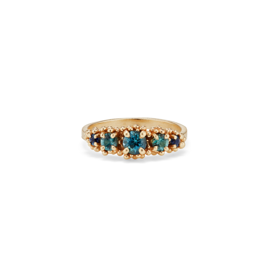 Sp-ring Fling...  This showstopper ring features five gorgeous tonal teal and blue sapphires interlaced with fine 14ct yellow gold granulation. It will be part of a selection of pieces on show at <a href="/morganjewellery/">anne morgan</a> for their Sp-Ring Fling 2023 Exhibition opening on 7 March.
.
.
.