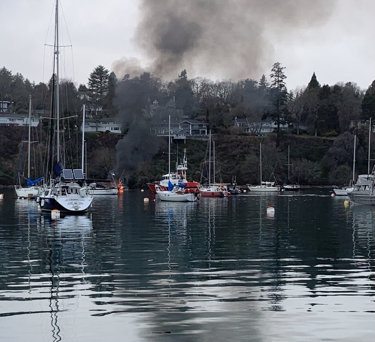 SaanichFire's tweet image. Boat fire is almost to the waterline. Coast Guard making sure the debris is contained