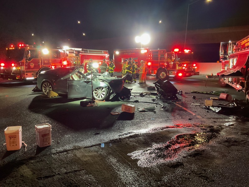 ContraCostaFire's tweet photo. Slow down and move over when approaching emergency vehicles. Truck 1 was struck by a Tesla while blocking I-680 lanes from a previous accident. Driver pronounced dead on-scene; passenger was extricated &amp; transported to hospital. Four firefighters also transported for evaluation. https://t.co/YCGn8We1bK