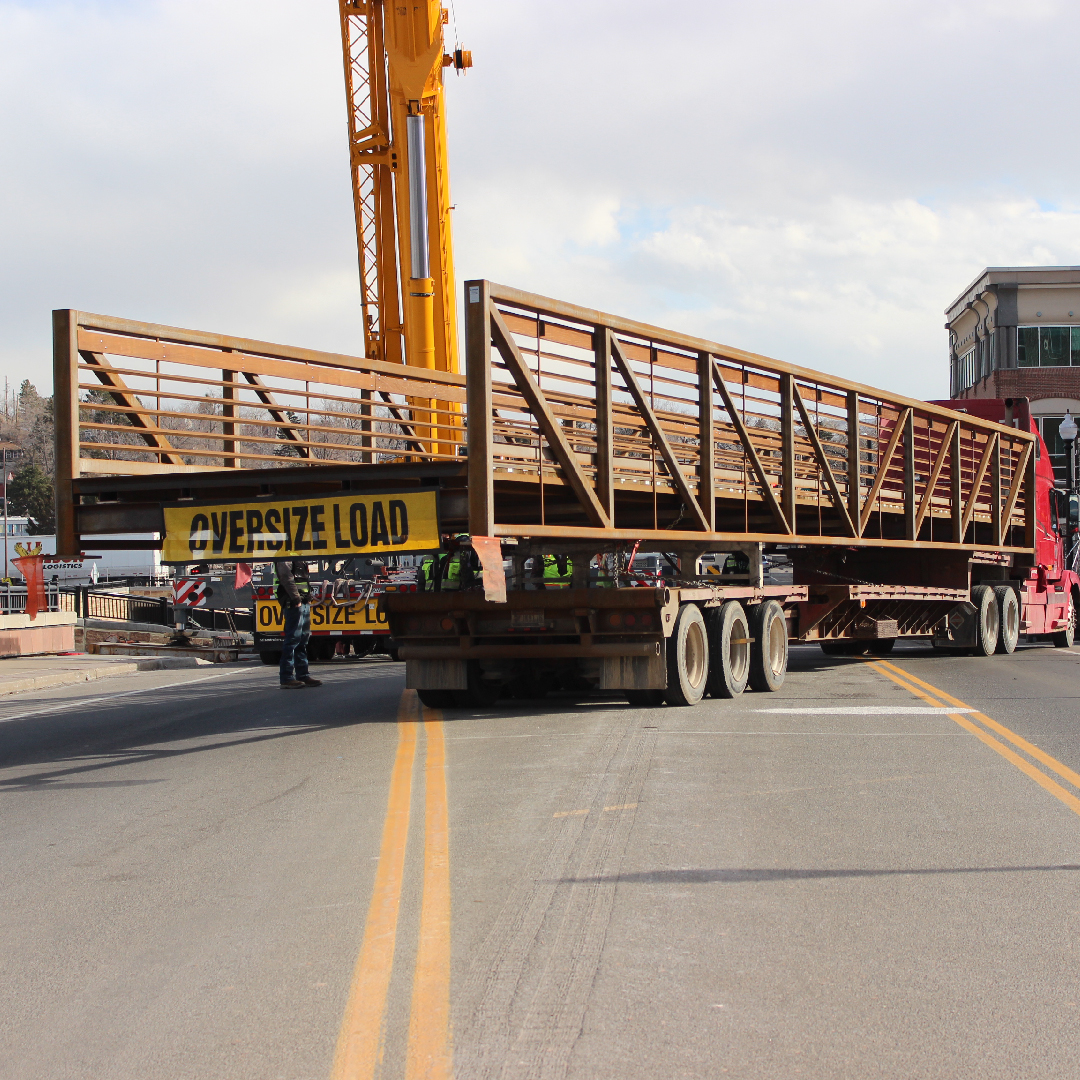 bridge on back of truck with crane in the background