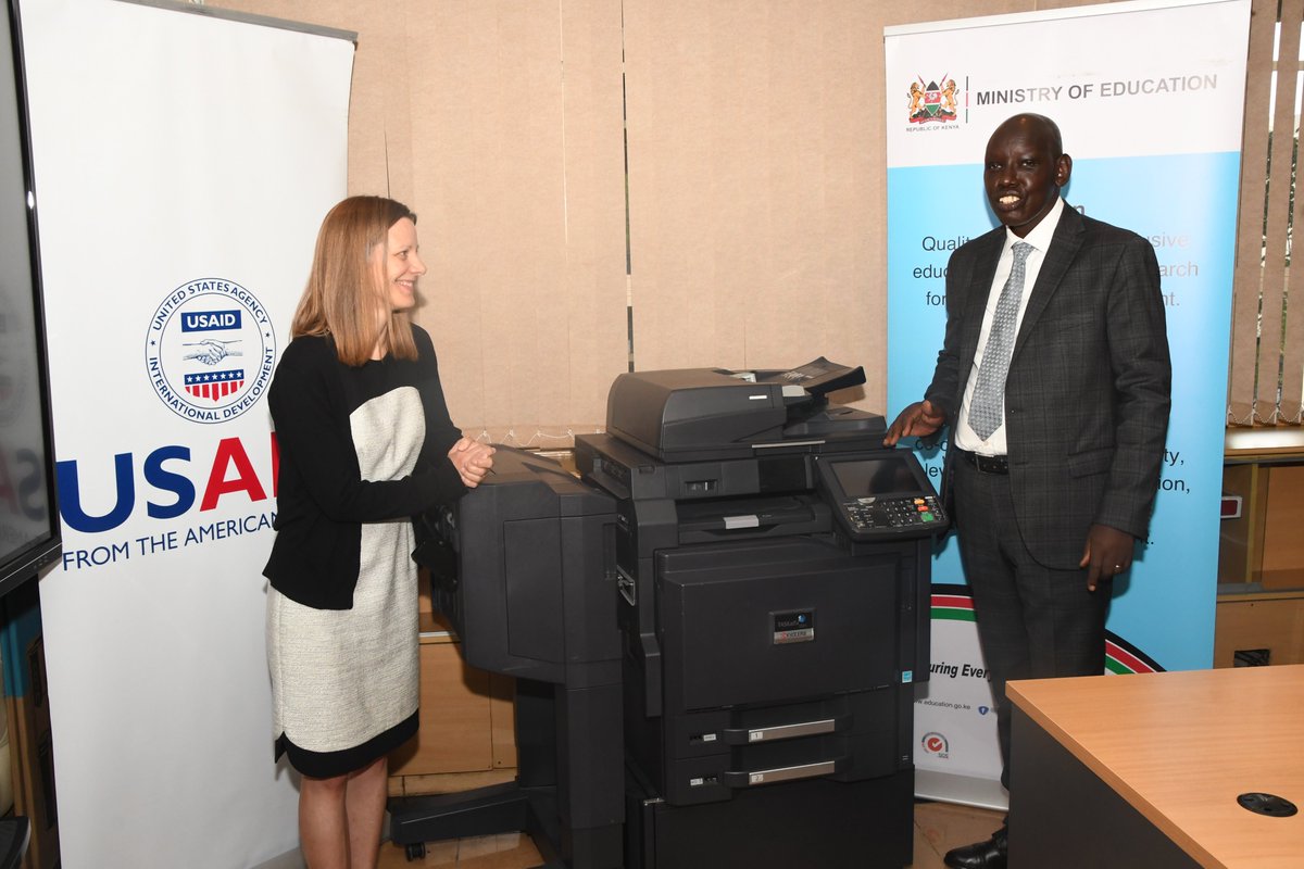 EduMinKenya's tweet photo. The Principal Secretary for the State Department for Basic Education, Dr. Belio Kipsang receives a state of the art photocopier  from @USAIDKenya official in charge of Education and Youth Affairs, Ms Amy Pekol, in his office. https://t.co/zL2ZpQDq0E