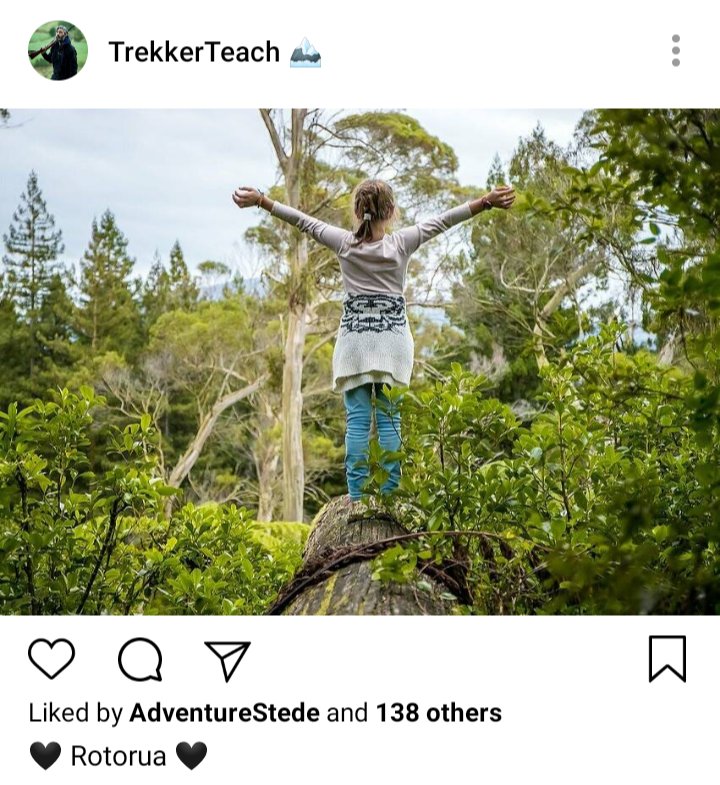 Ed's IG. Photo of Alma with her arms outstretched over a forest. Caption reads "🖤Rotorua 🖤" 
