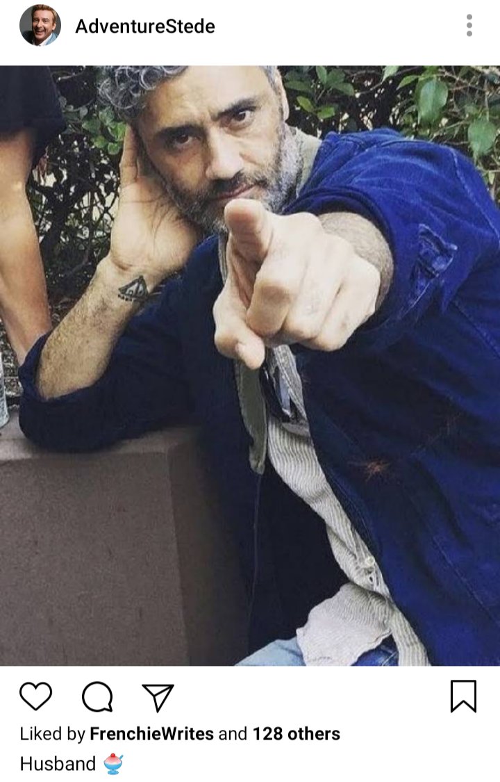 Stede's IG. Photo of Ed pointing at camera. Tattoo of a marae on his wrist. Caption reads "Husband" 
