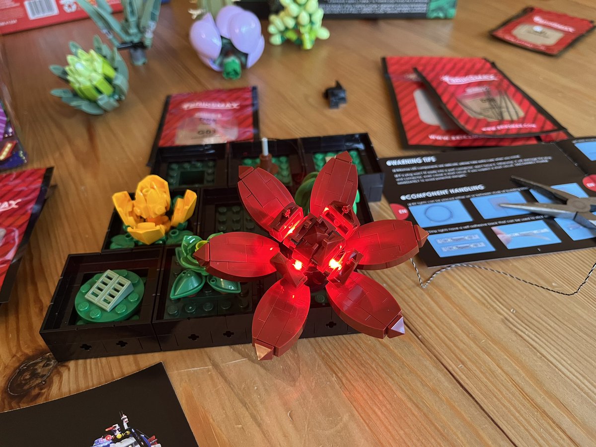 angelgrrl813's tweet photo. I bought a #BriksMax lighting kit for my LEGO Succulents set. It’s tricky and requires a lot of dexterity, but I finished the first flower and am already very excited. 🤩

(My phone camera isn’t doing the glow effect justice.) https://t.co/ODiLU7tczI