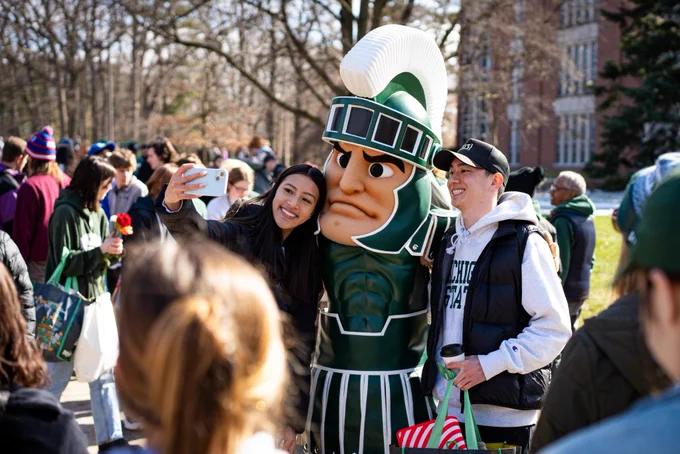 Two Spartans take a selfie with Sparty