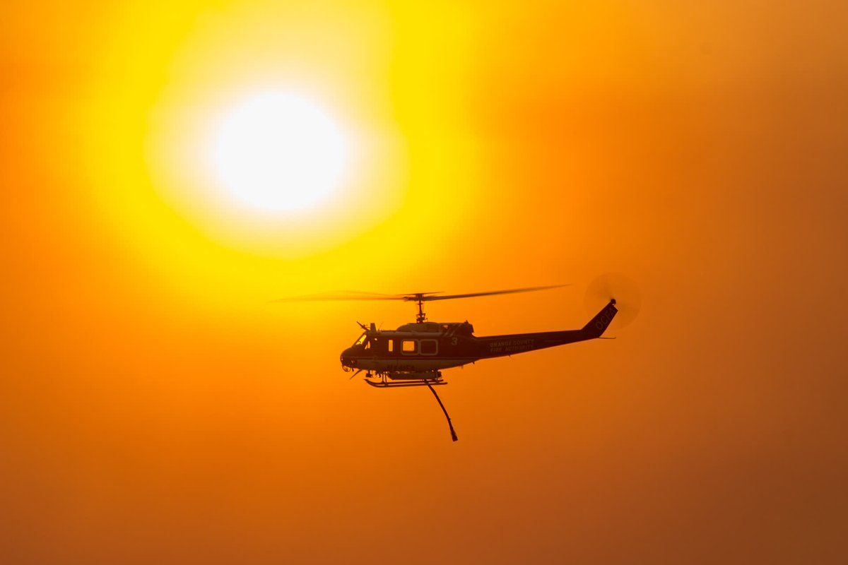 AirAttackMag's tweet photo. A Bell 205 that was operated by the @ocfaairops heading back to the fireground with a full load. 📷 - @airtoartphoto https://t.co/8mXrIRwM5L