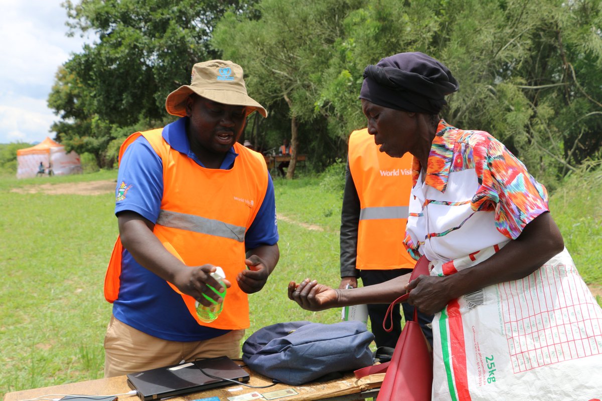 WorldVisionZim's tweet photo. #COVID19 protocols as prescribed by @MoHCCZim and @WHO_Zimbabwe are still being observed by our partners and staff during food distributions. #LeanSeasonAssistance #FoodAssistance #WorldVisionZim https://t.co/uIpg13QHyK