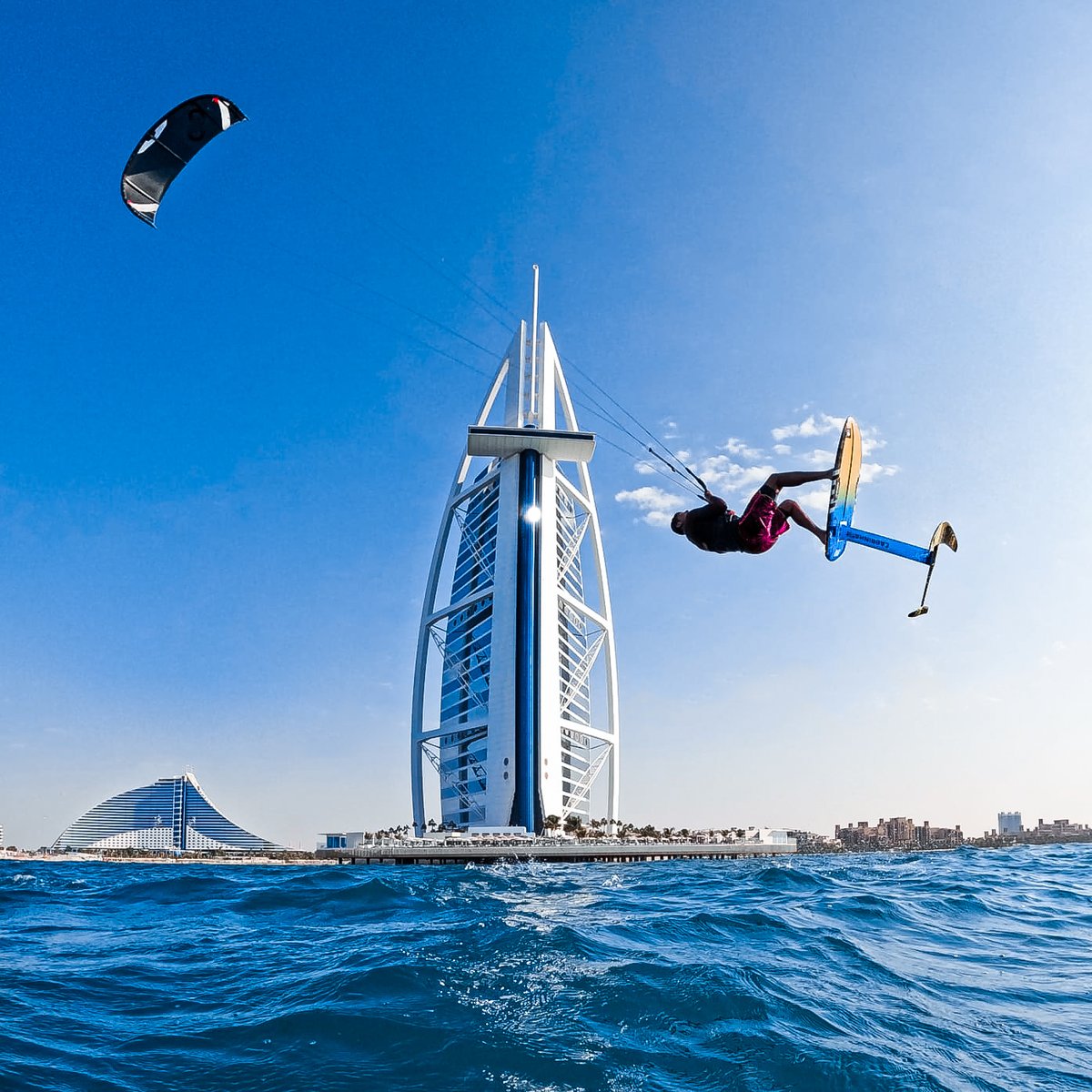 GoPro's tweet photo. Photo of the Day: Taking flight 🚀 Nour El scored a sweet view of Dubai on his kite foil.

#ProTip: Use Burst Photo Mode to snap a series of rapid-fire photos at a rate of your choosing. It makes capturing fast-moving action a breeze 💨

#GoPro #Kitesurfing #Dubai #Kiteboarding https://t.co/oAuhzMXlWS