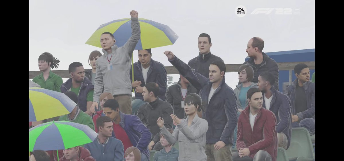 Hey @Codemasters, Statement please. 🙏🙏🙏
What's this guy doing?
On the Cinematic Mode I recognized, this is randomly and some of the fans on the grandstands are doing this. 
That shouldn't be a normal F1 viever, I guess...??? 🌚