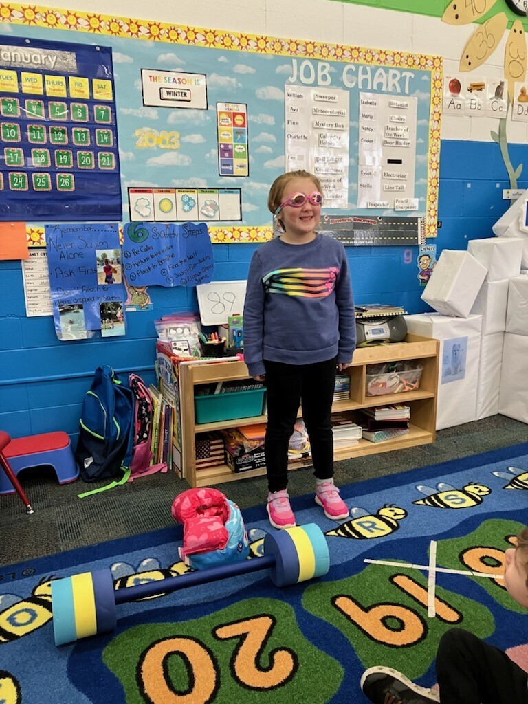 Meet Nancy! Nancy had the opportunity to be "Teacher for a Day" at her preschool, and she chose to be a Swim Teacher! She did an awesome job talking about how she is currently working on her floats. Way to go, Nancy🥳! We are so proud of you💙💛