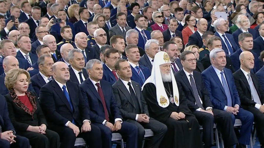 Patriarch Kirill can be seen watching Putin's address from the front row