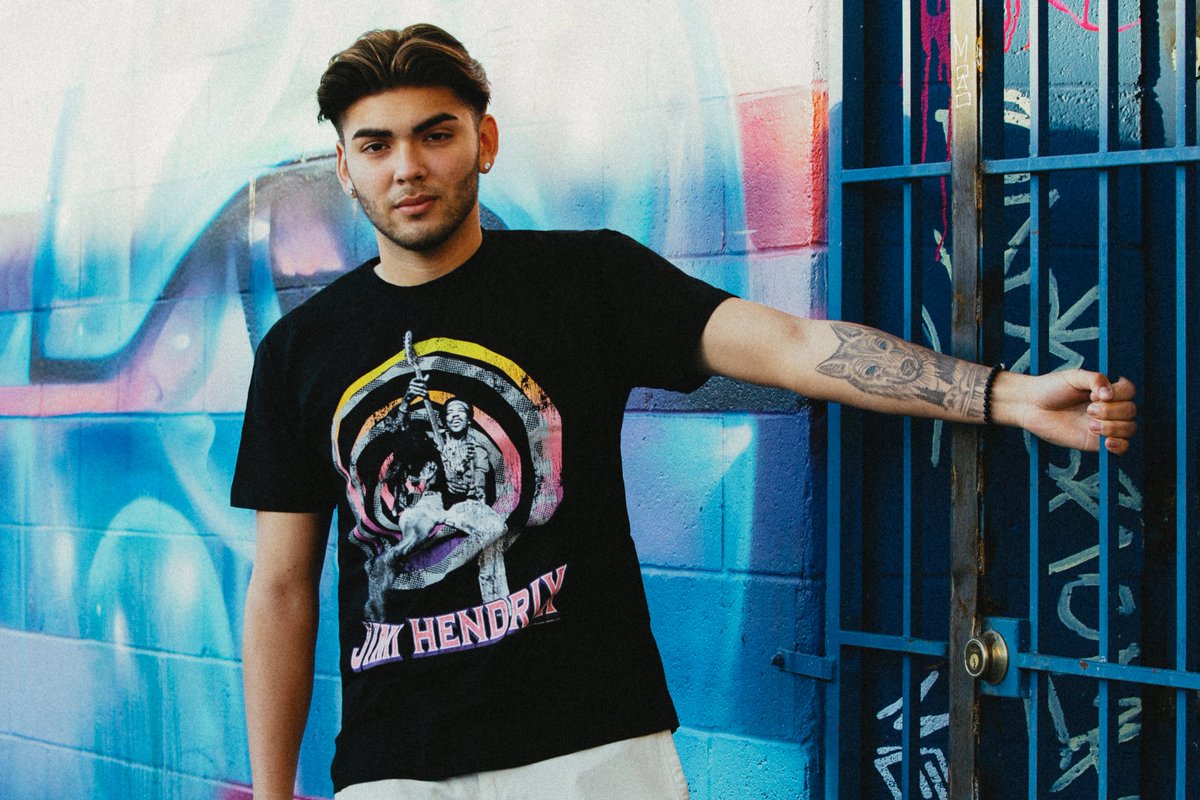 Time to "jam out" wearing our Jimi Hendrix Swirly Jimi Tee 🎸 Design features the famous American guitarist, a perfect tee for any classic rock fanatic! #jimihendrix #americanguitarist #jimihendrixexperience #bandmerch #bandtees #officiallylicensed #goodietwosleeves #gts