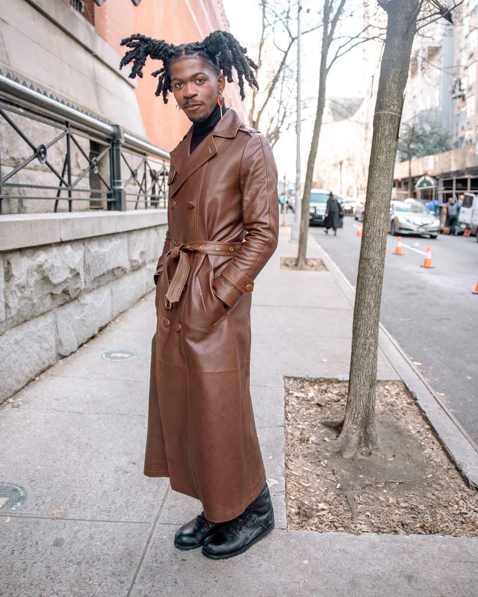 Coach's tweet photo. Feelin himself. 😻 #LilNasX turns heads in runway look #9—a black turtleneck and leather trench—and the people can't help but comment. #CoachFall23 #NYFW #CoachNY https://t.co/pvmfO2iluM