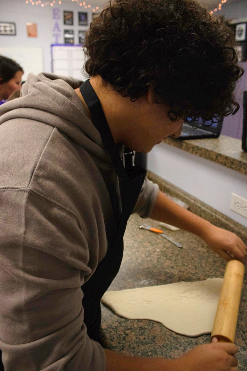 PHS_Warrior's tweet photo. Prepping his food in Culinary Arts, sophomore Ayden Marshall rolls out the dough for his pizza. Photo by J. Robert https://t.co/iubRdv0cLn