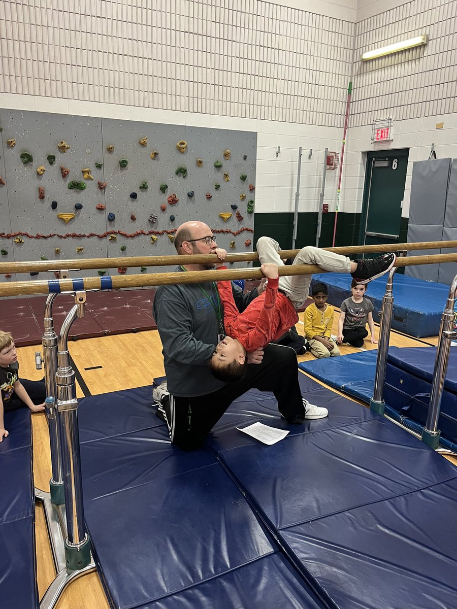 Coach K teaching some parallel bar skills.