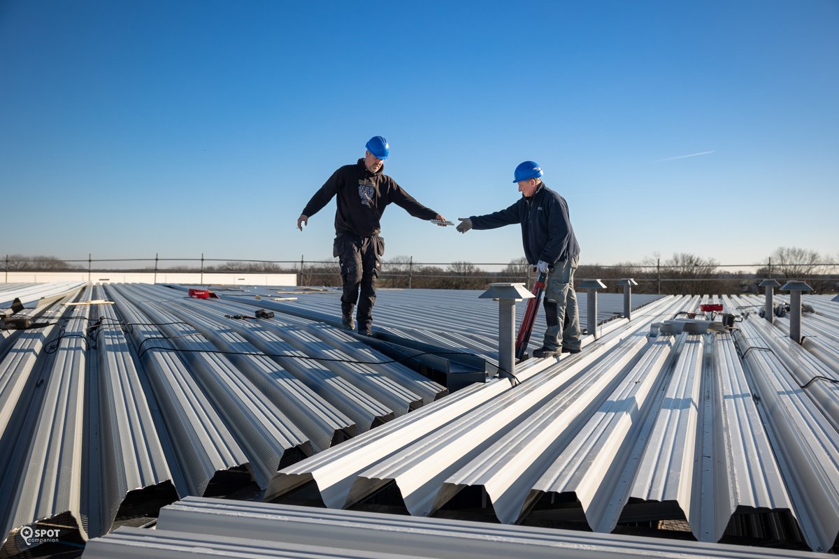 Mooi om te zien... TEAM work! Met vereende kracht wordt het dak van de nieuwbouw van Brabo Verpakking dichtgelegd. Het steeldeck ligt er al grotendeels op en binnenkort volgt de isolatie en de dakbedekking.
