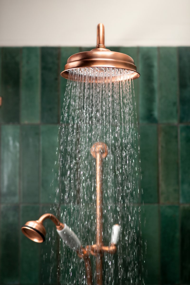 We're thrilled to see the new Living Copper finish from @swadlingbrassware. It looks stunning on this Invincible collection Deluge and Hand Shower, especially against the dark green tiles. instagram.com/p/CoMYwfSojML #greenbathroom #livingcopper