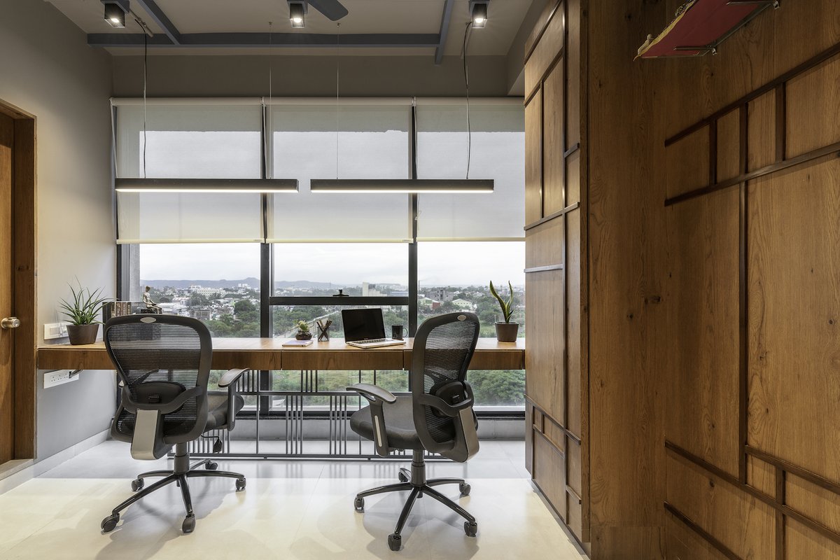 Workspace with a view! The general work desk is arranged across the glazing that overlooks the cityscape. The geometric language lends a smart crispness to the space. #interiordesign #porticodesignconcepts #porticointeriors #homedesign