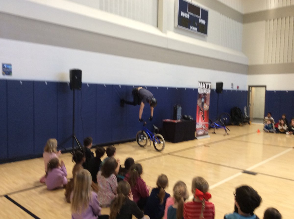 ksharp44's tweet photo. What a great surprise and delight for the kids at CCE. Matt Wilhem showed us some cool bike tricks and encouraged us to never give up, work hard and be someone’s Batman. #CCEthespace4u https://t.co/9nTJ54CYvG