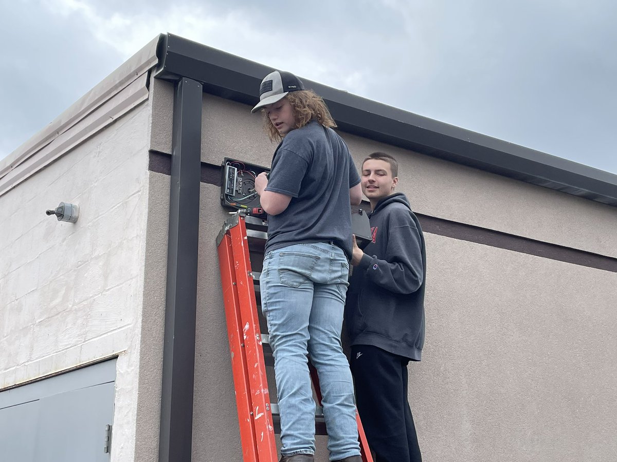 Giani Volini and Xander Bush replacing sodium vapor lights with LED lighting on outside of Williamson co special education office. #williamsoncocte