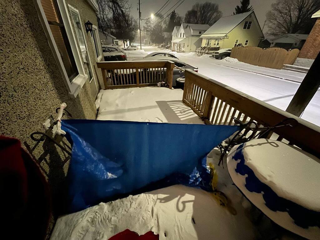 RebeccaBredin's tweet photo. If you remember the great snow drift of Christmas Eve, you’ll understand why I have tied up a tarp with shopping bags on deck chairs to try and reduce the drift. If I can open the door tomorrow and it not be the deepest snow possible, it will be a victor… https://t.co/yfN6QQwwjy https://t.co/bYWynv8nyi