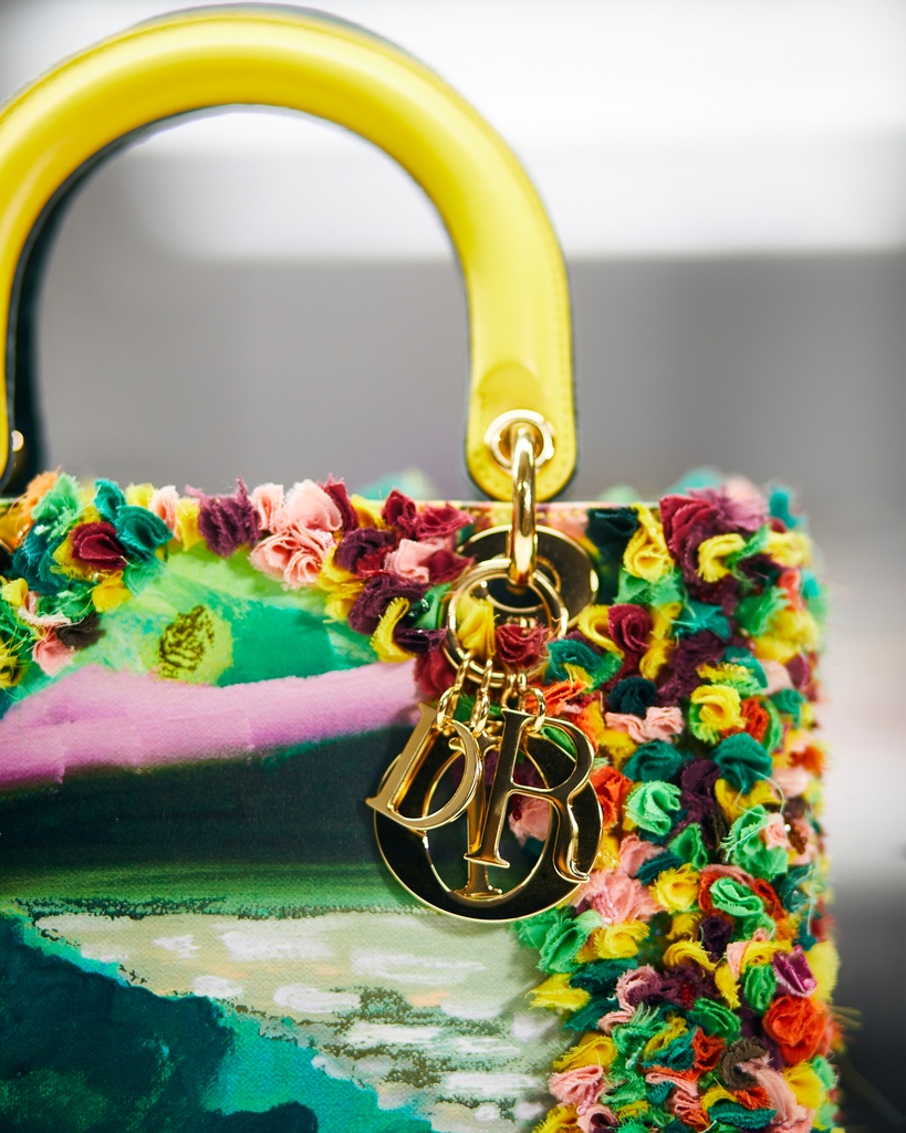 Dior's tweet photo. Known for her dreamlike landscapes, Shara Hughes has redefined the #LadyDior bag in the 7th edition of #DiorLadyArt with enchanting optical artwork featuring portals into these ethereal gardens that serve as an ode to Monsieur Dior's love of nature https://t.co/vSufZoyI7Q. https://t.co/nrBqwqMqdJ