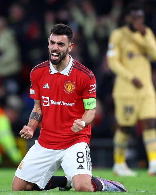 Bruno Fernandes drops to his knees to celebrate Manchester United's win against Barcelona