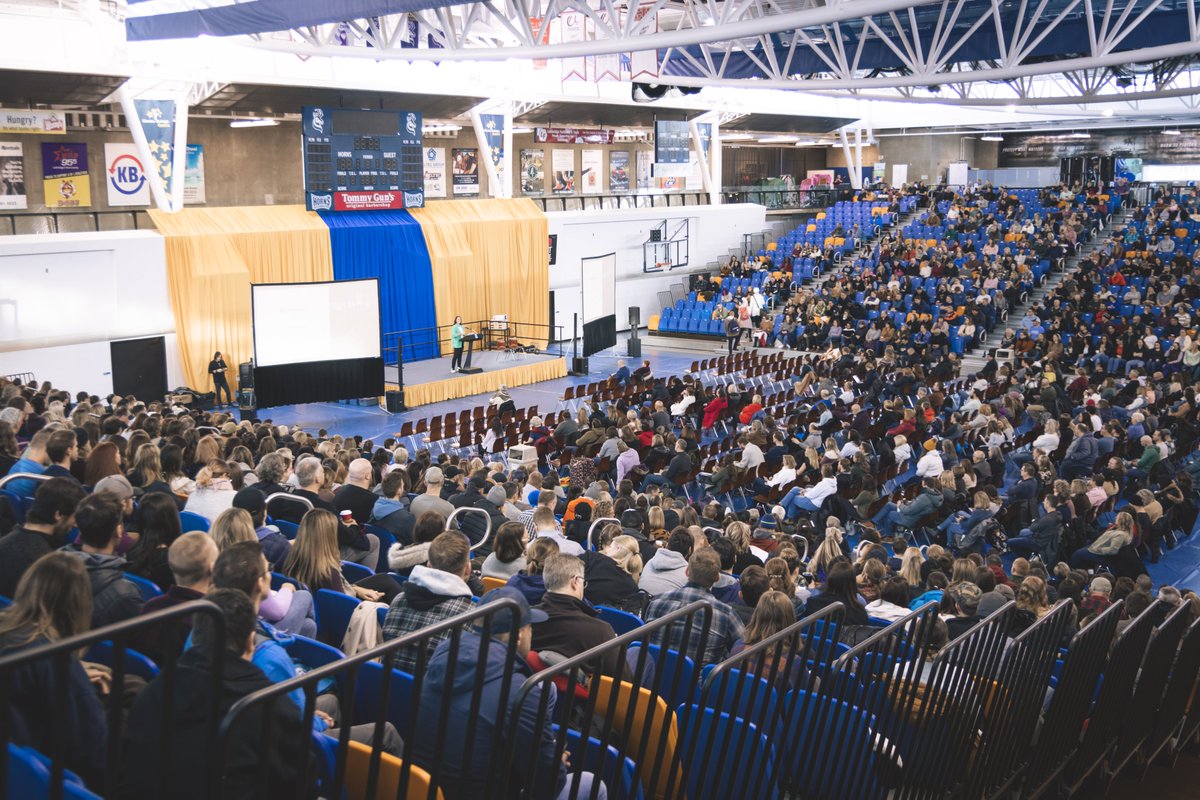 ULethbridgeEdu's tweet photo. @SWATCA has taken over campus, teachers from across southern Alberta are everywhere (we love to see it) and the energy is crazy! If you're attending, be sure to stop by our grad studies table in the 1st Choice Savings Centre AND say hi to our student volunteers in red! 🍎📚 #yql https://t.co/ExtzO1PYsL