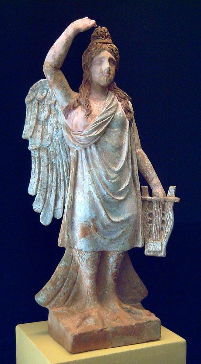 chapps's tweet image. Holding a zither in her left hand, her right hand raised over her head in a typical gesture of lamentation, this 4th c. BC polychrome terracotta siren sings a song of mourning. Certainly placed in a tomb, perhaps as a guardian. Greek, S. Italy (Canosa) - now in Madrid.  1/