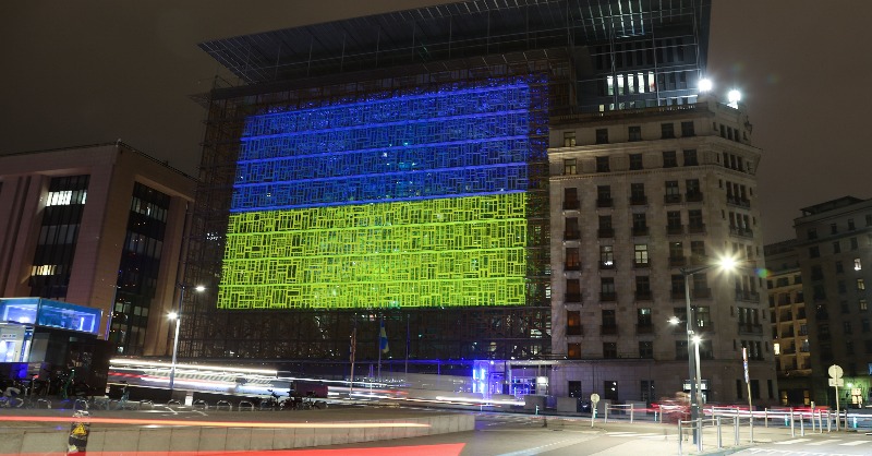 EUCouncil's tweet photo. One year ago, Russia started its brutal war of aggression against Ukraine. 

🇺🇦🇪🇺 We are illuminating the Council’s Europa building to mark the EU’s unwavering support for Ukraine. 

We will #StandWithUkraine for as long as it takes. https://t.co/AmJYVHT49s