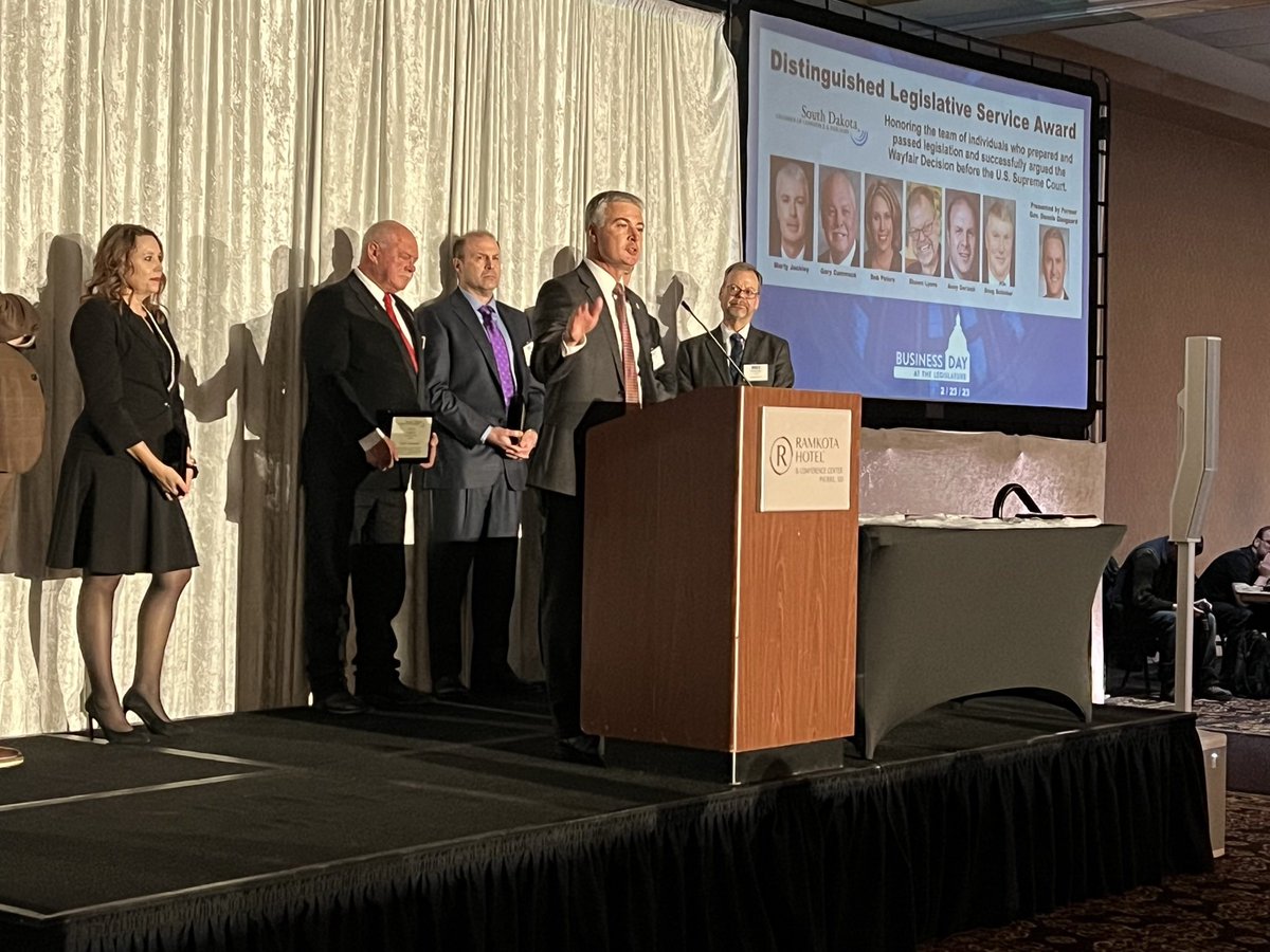 SDAttorneyGen's tweet photo. Attorney General Marty Jackley speaks on behalf of six government and business leaders honored Thursday night by the S.D. Chamber of Commerce for successfully appealing and arguing the Wayfair decision before the U.S. Supreme Court five years ago. #BusinessDay2023 https://t.co/1F91oPxspi